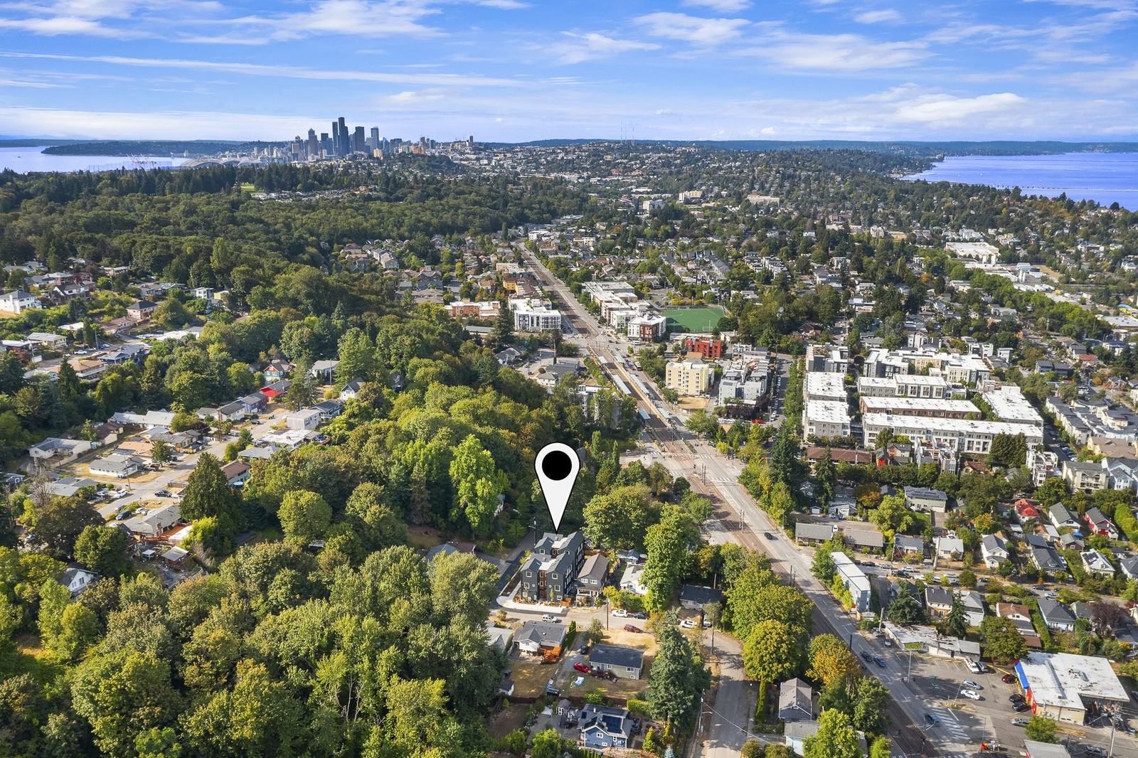 Aerial view over Columbia City toward downtown Seattle with the site marked