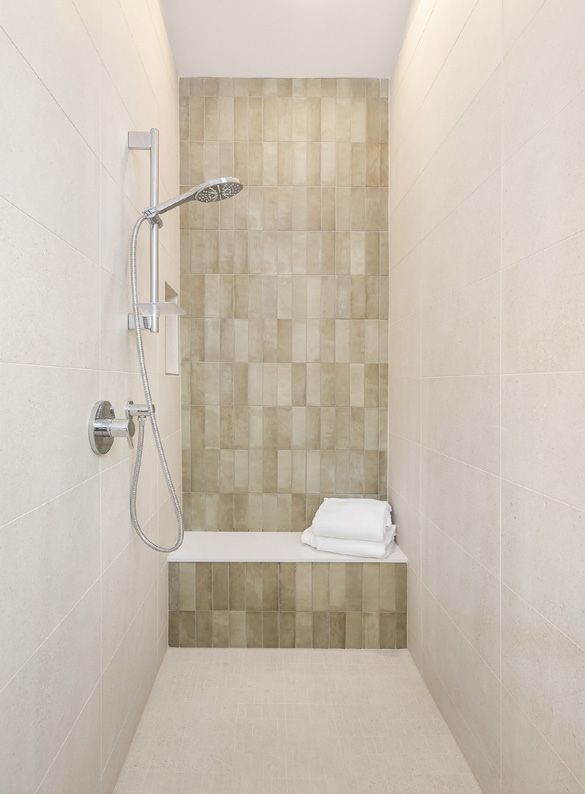 Tiled walk-in shower with a built-in bench