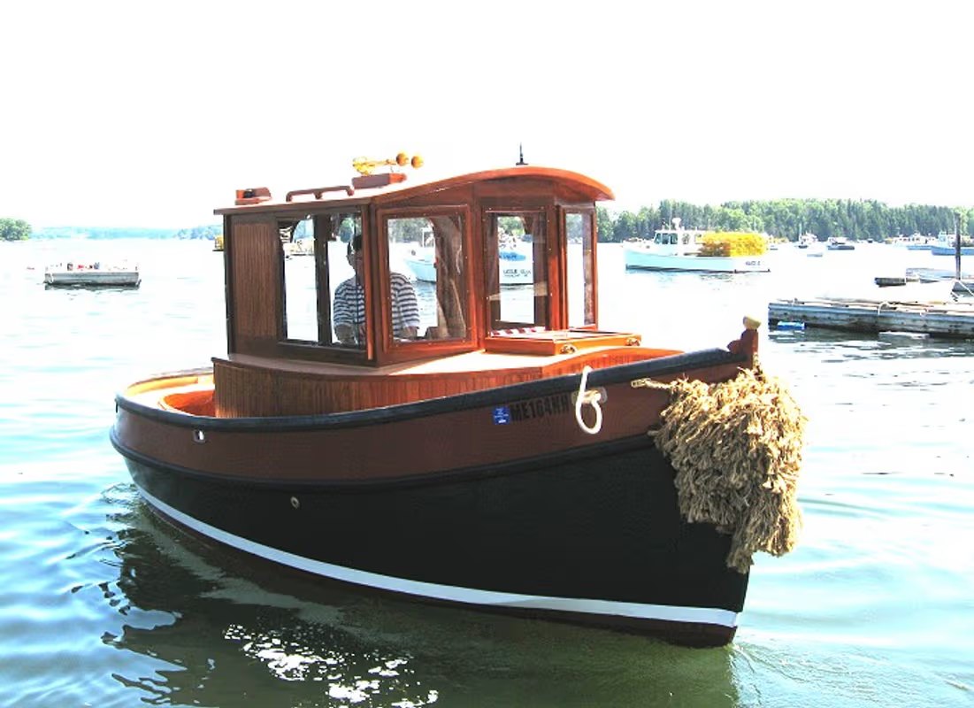 Goliath, a mini tug with a varnished wheelhouse, Maine