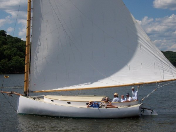 Kathleen, the Hanley catboat, under sail with a cockpit full of people